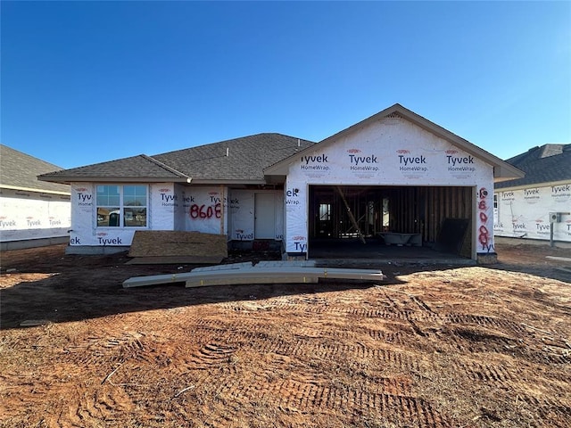 property in mid-construction featuring roof with shingles and an attached garage