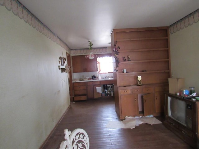 111 W Hillcrest Ln, Hobart, OK 73651 - kitchen with light wood-type flooring, brown cabinetry, open shelves, and baseboards