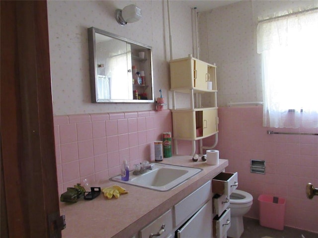 111 W Hillcrest Ln, Hobart, OK 73651 - bathroom featuring tile walls, wallpapered walls, wainscoting, and toilet