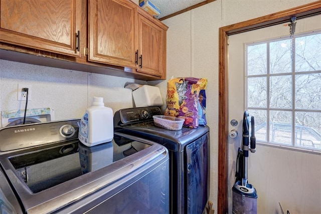 washroom with cabinet space and independent washer and dryer