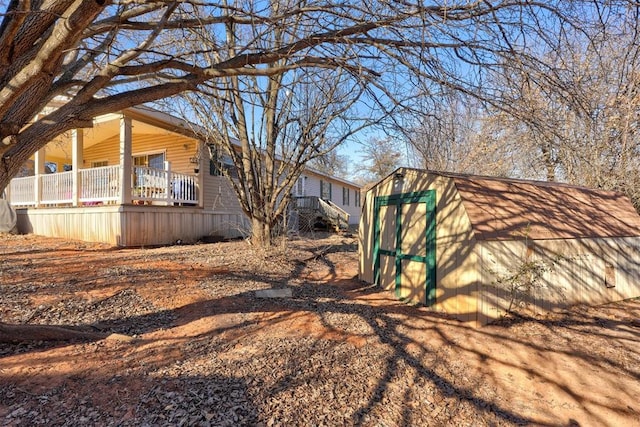 view of yard featuring an outbuilding and a shed