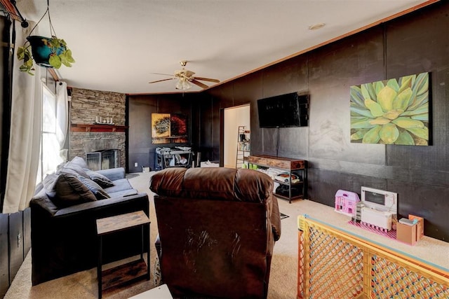 living room featuring a fireplace, a ceiling fan, and carpet flooring