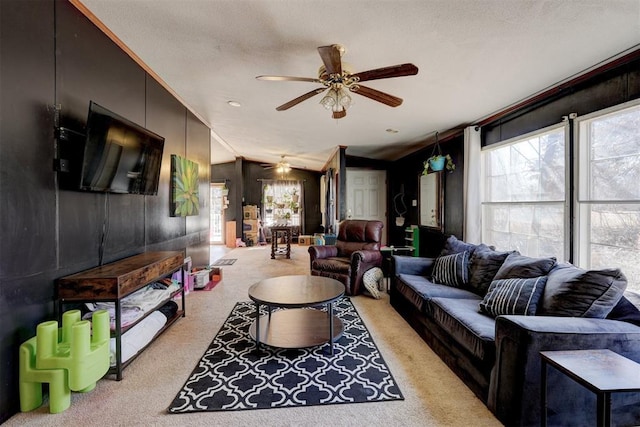 living room with vaulted ceiling, carpet floors, a textured ceiling, and a ceiling fan