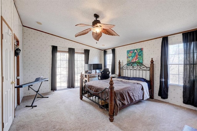 bedroom featuring carpet floors, a textured ceiling, and wallpapered walls