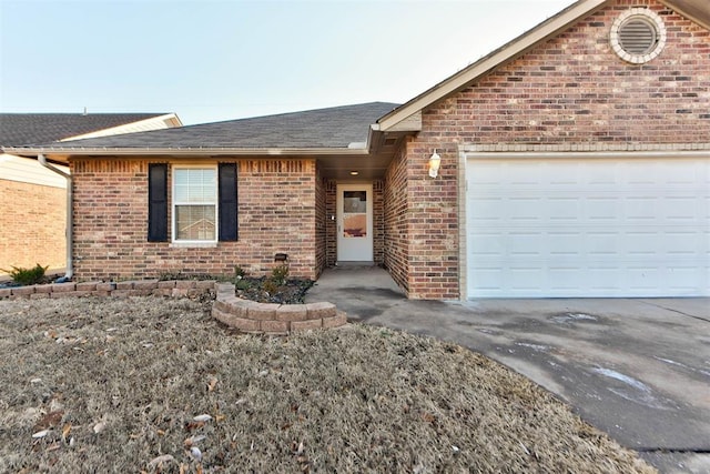 ranch-style house with driveway, an attached garage, roof with shingles, and brick siding