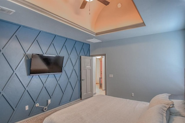 bedroom featuring carpet floors, an accent wall, visible vents, and vaulted ceiling