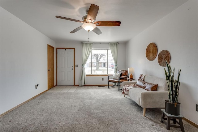 living area featuring light carpet and baseboards