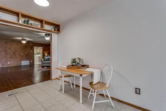 dining space with visible vents, ceiling fan, baseboards, and light tile patterned floors