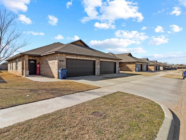 view of front of property with a garage, brick siding, a shingled roof, concrete driveway, and a front yard