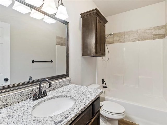 bathroom featuring  shower combination, vanity, and toilet