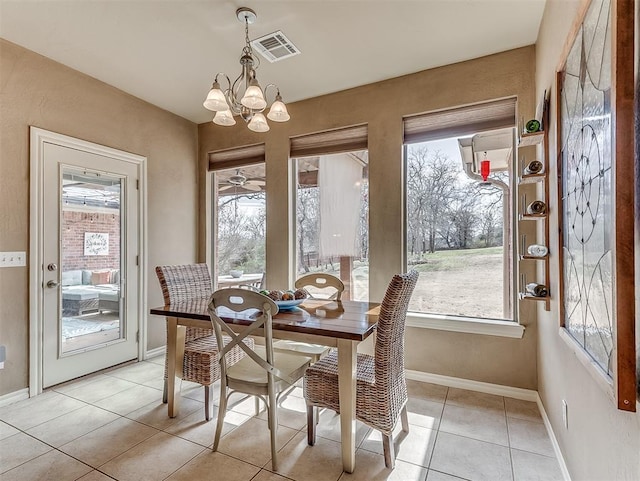 dining area with light tile patterned floors, plenty of natural light, visible vents, and an inviting chandelier