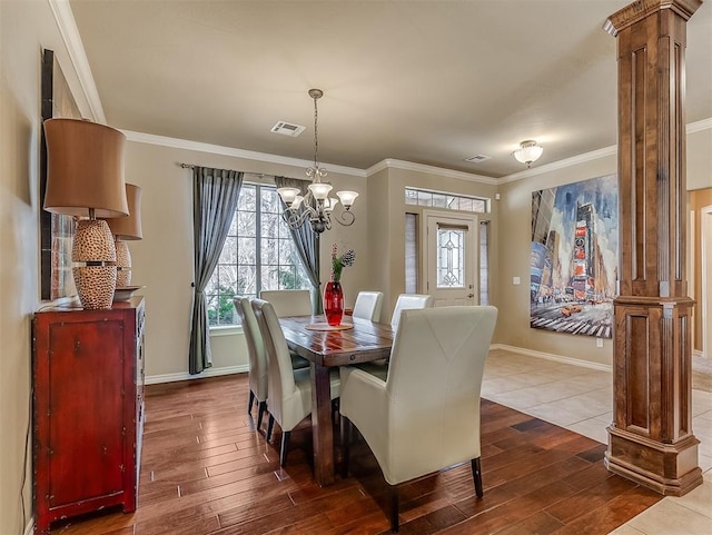 dining room with ornate columns, visible vents, and dark wood-type flooring