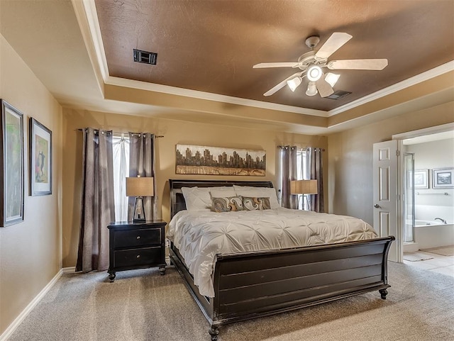 carpeted bedroom featuring a raised ceiling, visible vents, and multiple windows