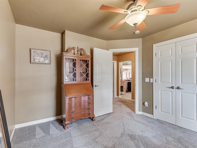 bedroom with a ceiling fan, carpet, baseboards, and a closet