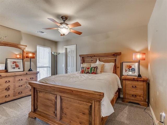 bedroom featuring light carpet, baseboards, visible vents, and ceiling fan