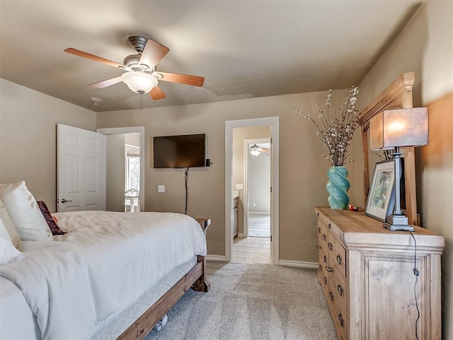 bedroom featuring light carpet, a ceiling fan, and baseboards