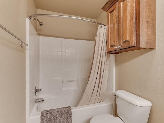 bathroom with toilet, shower / bath combo, and a textured wall