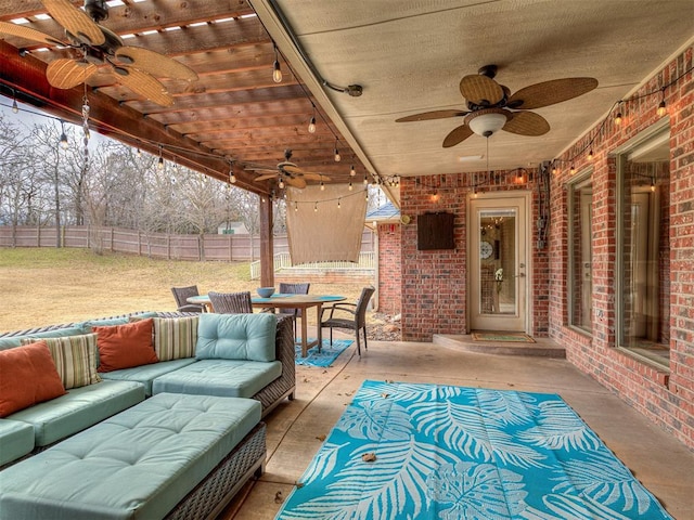 view of patio featuring a ceiling fan, outdoor dining space, outdoor lounge area, and fence