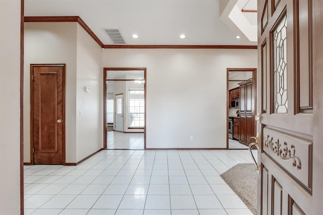 interior space featuring light tile patterned floors, baseboards, visible vents, and ornamental molding