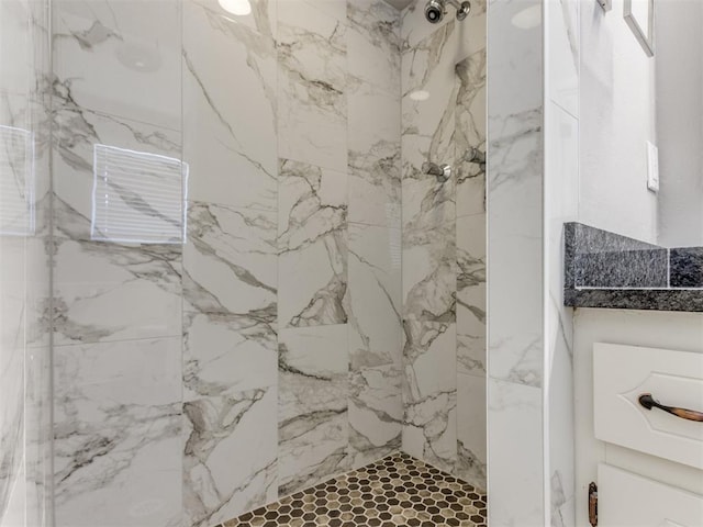 full bathroom with a marble finish shower