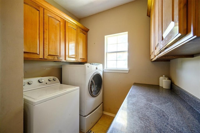 laundry area with cabinet space, independent washer and dryer, and baseboards