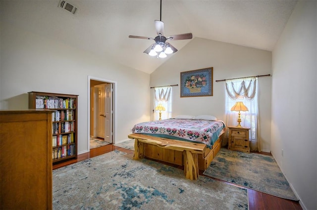 bedroom featuring lofted ceiling, baseboards, visible vents, and wood finished floors