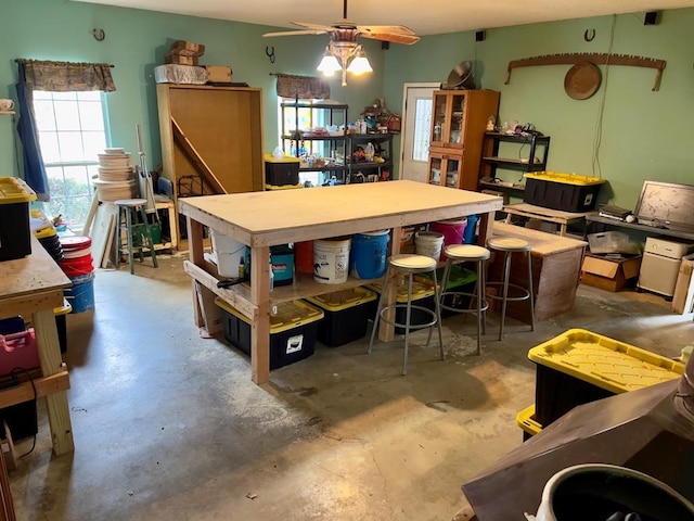 dining area with concrete floors and a ceiling fan