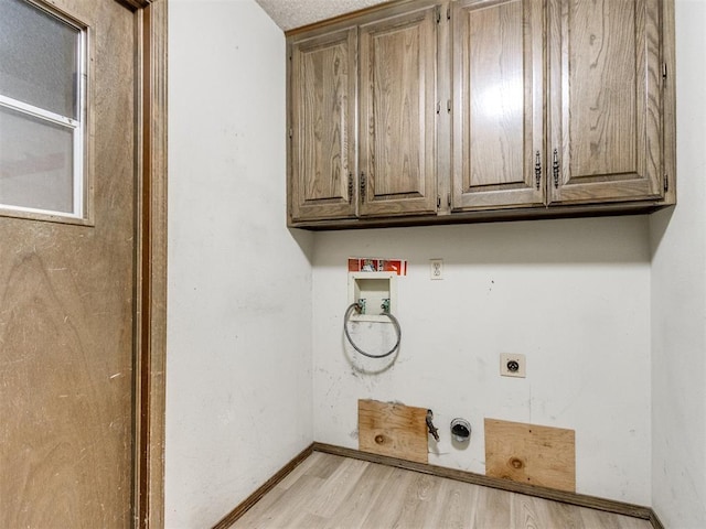 washroom with washer hookup, cabinet space, light wood-style flooring, electric dryer hookup, and baseboards