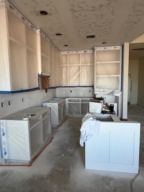 kitchen featuring light brown cabinets and unfinished concrete floors