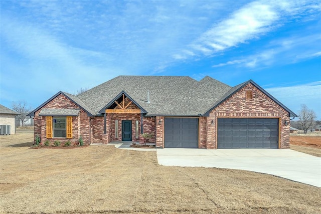 view of front of property with a garage, brick siding, a shingled roof, driveway, and a front yard