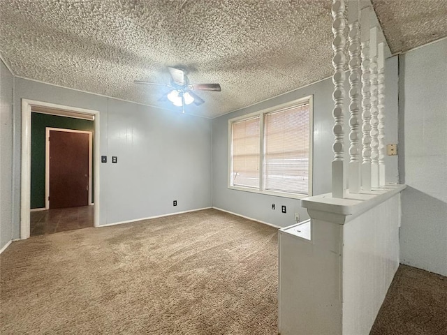 carpeted spare room featuring ceiling fan and a textured ceiling
