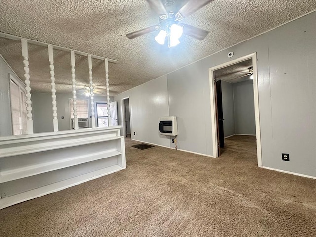 below grade area featuring carpet flooring, ceiling fan, a textured ceiling, and heating unit