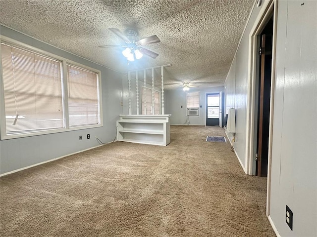 unfurnished room featuring ceiling fan, carpet floors, a textured ceiling, and radiator