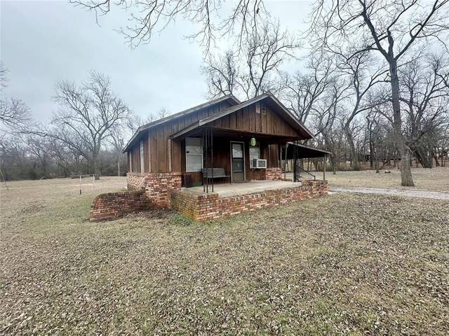 view of front of property featuring cooling unit and covered porch