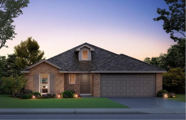 view of front of house with a garage, a front lawn, concrete driveway, and brick siding