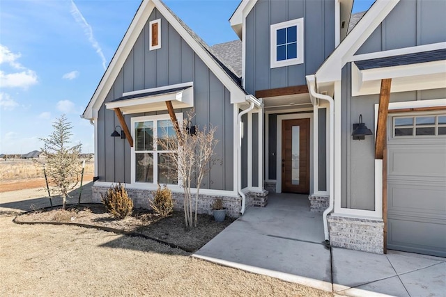 doorway to property featuring a garage and board and batten siding