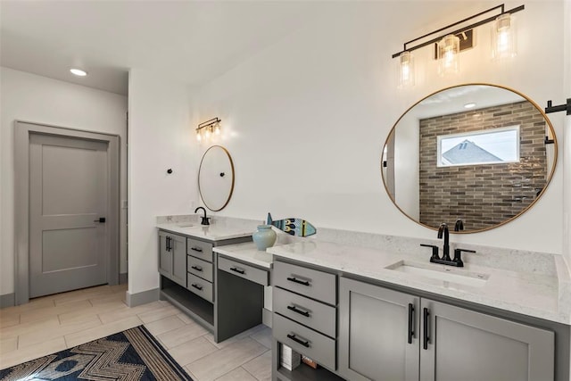 bathroom with two vanities, a sink, and recessed lighting