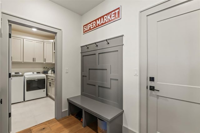 mudroom with independent washer and dryer and light wood-style floors