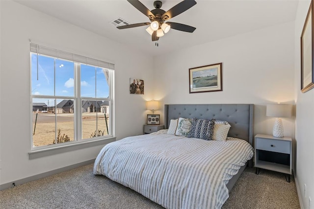 bedroom featuring carpet floors, visible vents, and baseboards