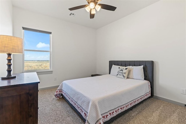 carpeted bedroom with ceiling fan, visible vents, and baseboards