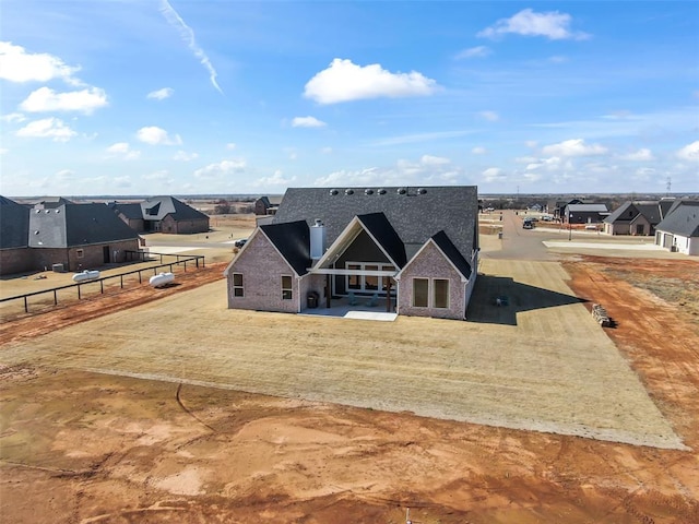 view of front of home featuring fence and a patio