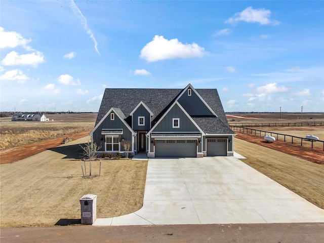 craftsman inspired home with a garage, a shingled roof, concrete driveway, fence, and board and batten siding