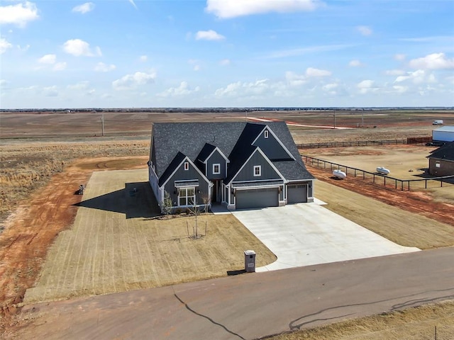 view of front of house with driveway and fence