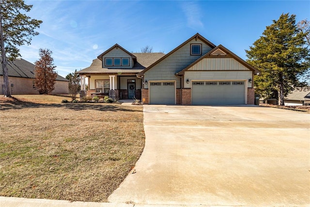 craftsman inspired home with an attached garage, covered porch, driveway, and brick siding