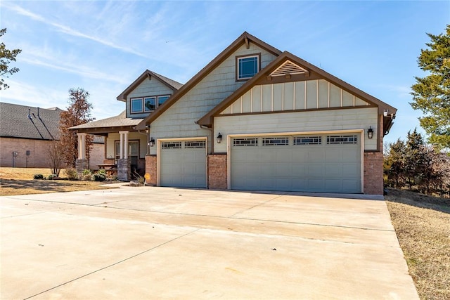 craftsman inspired home featuring concrete driveway, brick siding, board and batten siding, and an attached garage