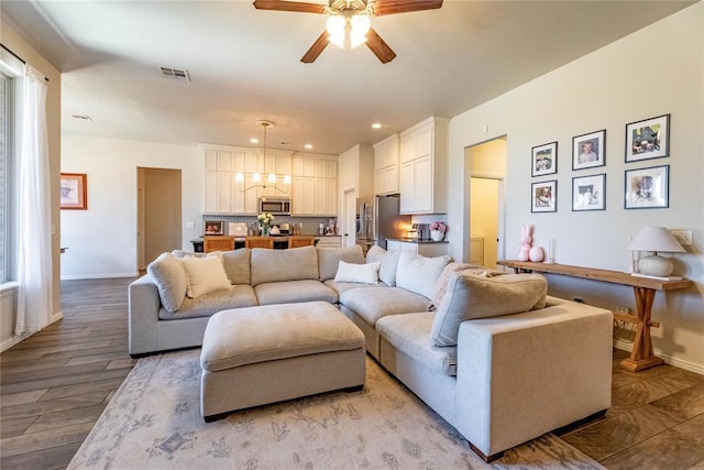 living area with a ceiling fan, light wood-type flooring, visible vents, and baseboards