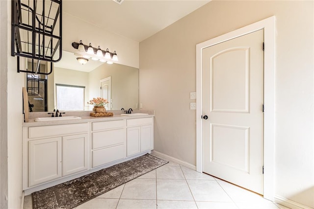 full bath featuring tile patterned flooring, a sink, baseboards, and double vanity