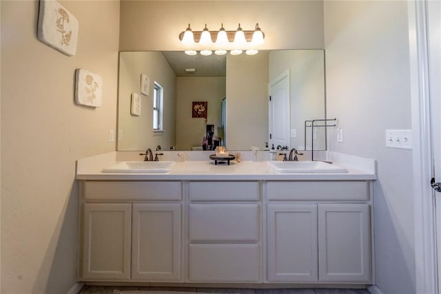 full bathroom with double vanity and a sink