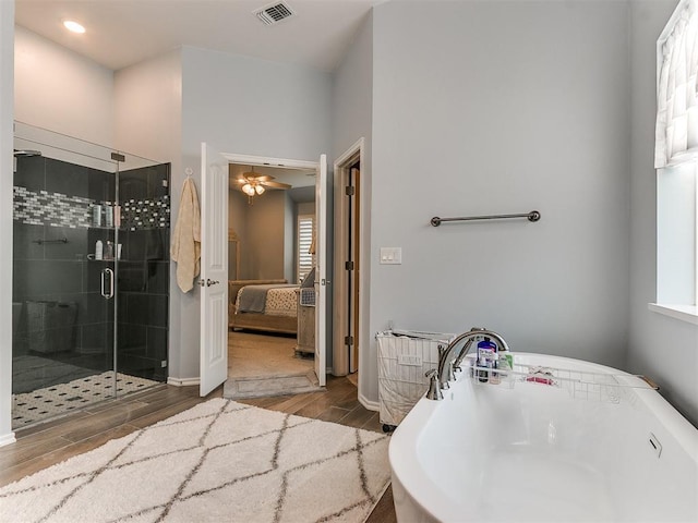 bathroom with a stall shower, visible vents, connected bathroom, a soaking tub, and wood finished floors