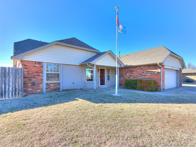 view of front facade with a shingled roof, fence, a front lawn, and brick siding